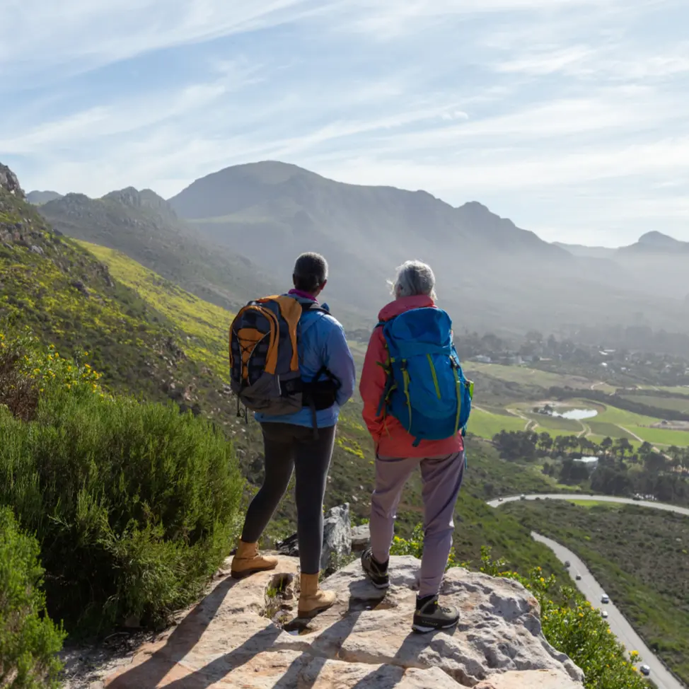 Mature female walkers resting on a mountain hike