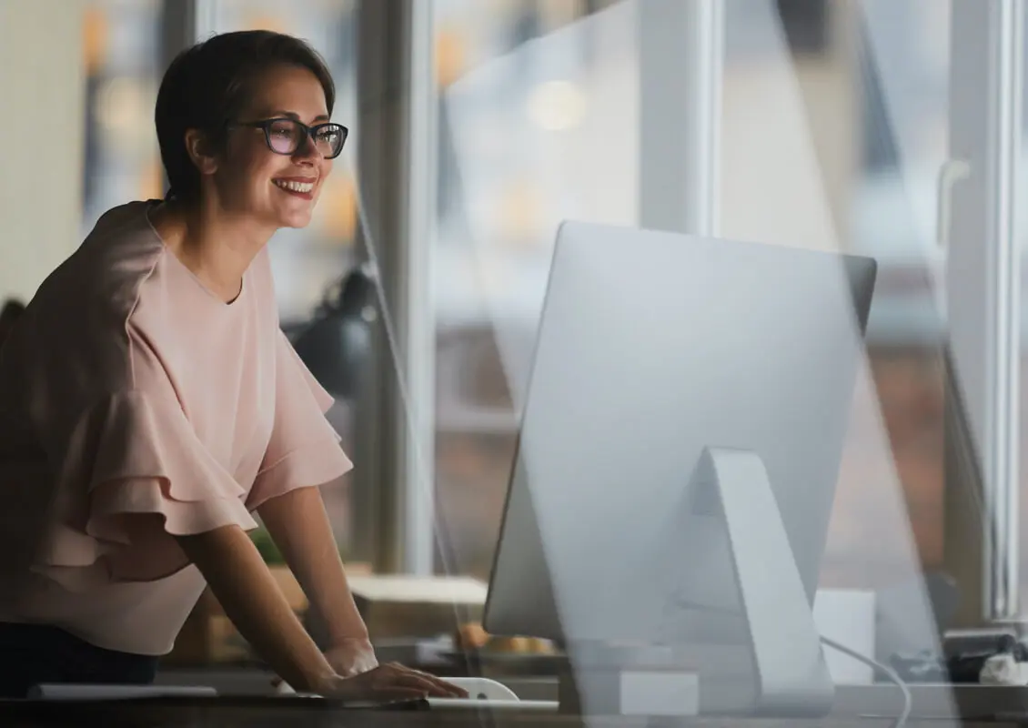 smiling woman viewing monitor