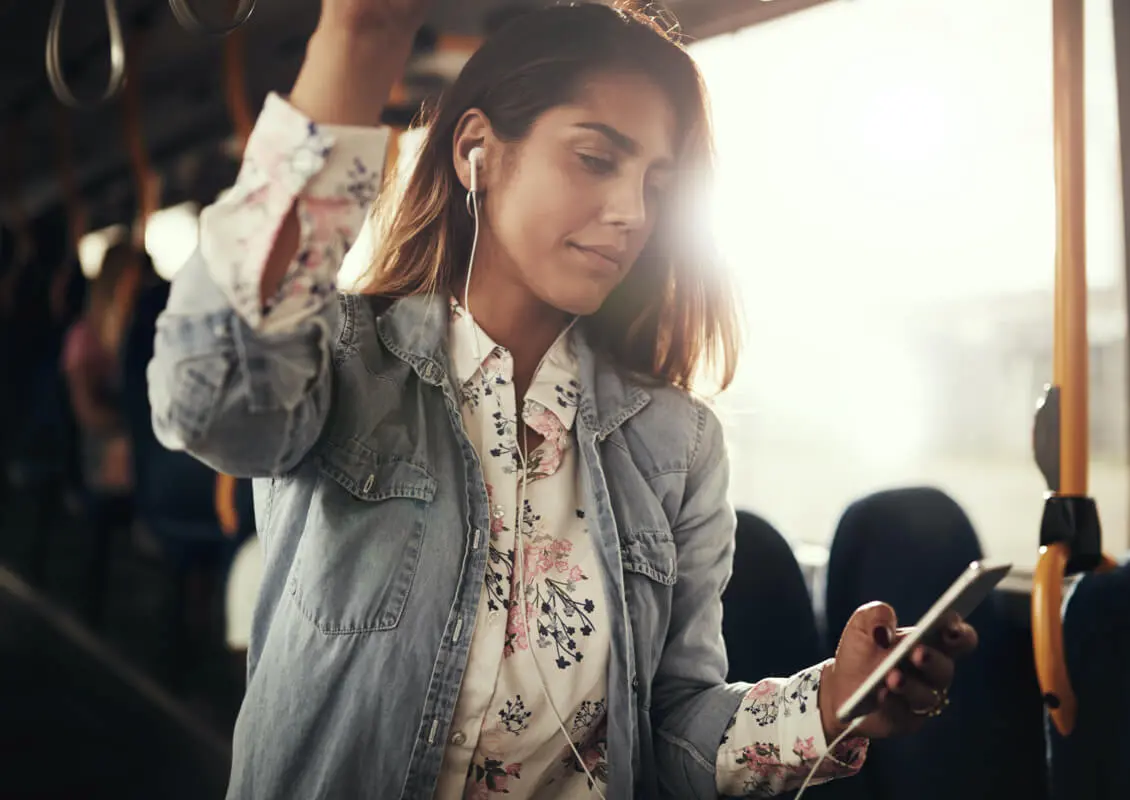 young woman on bus using cellphone