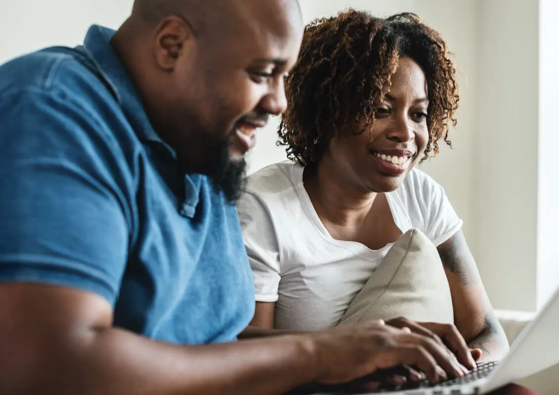 happy couple using laptop