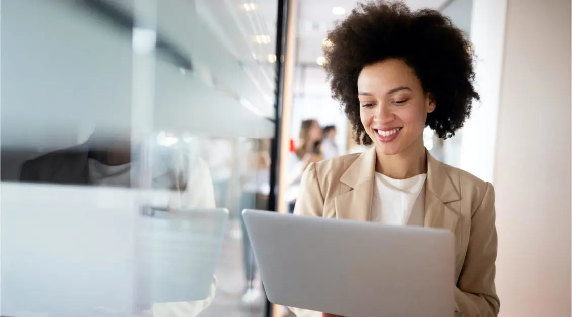 woman holding laptop in business environment