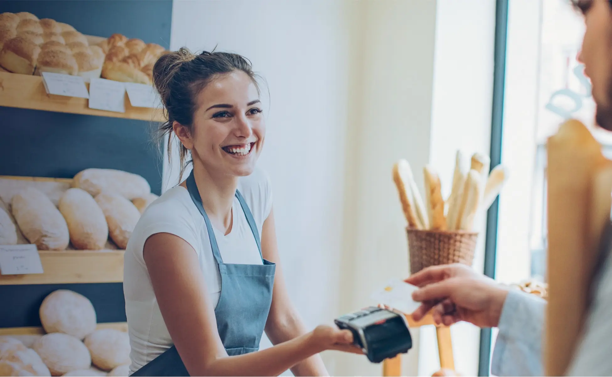 Woman holding credit card machine for customer