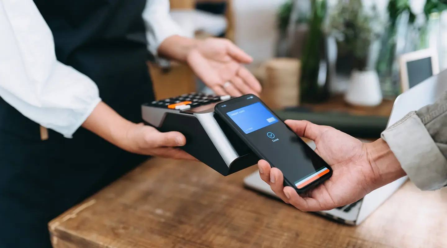 A person using their phone to pay for something with their phone.