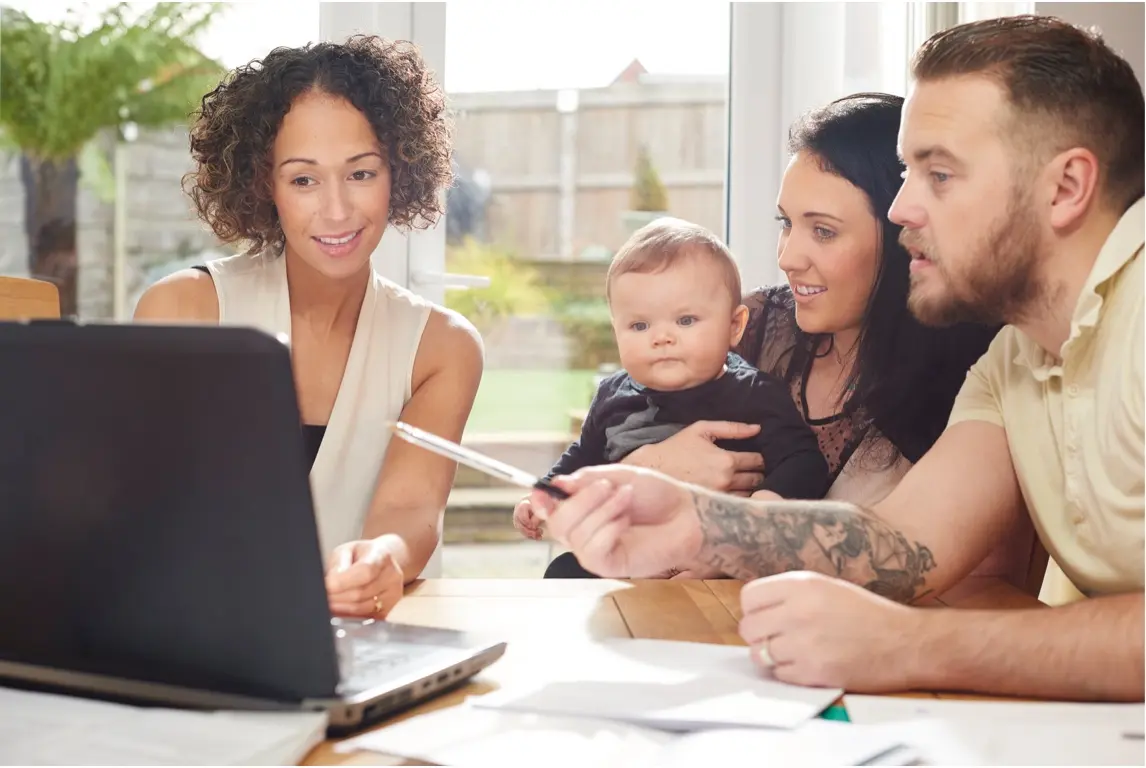 Young family and financial advisor looking at a computer screen