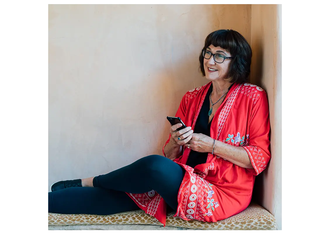 Woman sitting on the floor on her cellphone